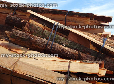 Stock image of split logs at lumber yard / timberyard stacks / bundles