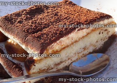 Stock image of tiramisu layered coffee sponge cake dessert with spoon