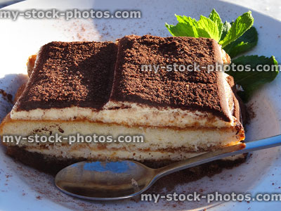 Stock image of tiramisu layered coffee sponge cake with powdered chocolate