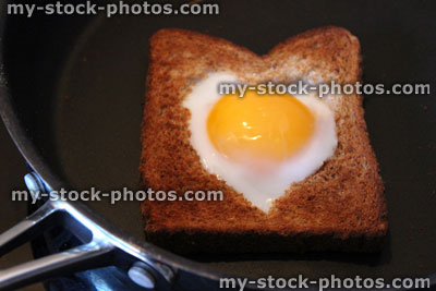Stock image of egg in hole toast / love heart fried egg
