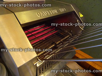 Stock image of industrial stainless steel conveyor toaster, hot grill, cooking equipment