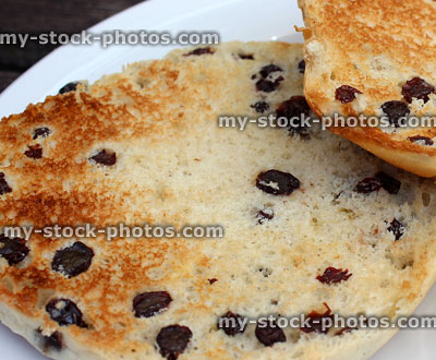 Stock image of toasted teacakes on white plate, currant buns on plate