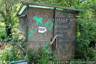 Stock image of funny outside toilet shed in garden with disabled toilet sign