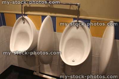 Stock image of urinals in a men's public toilets / restroom