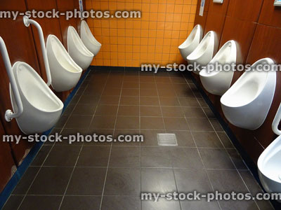 Stock image of white men's urinals in rows, public toilets / restroom, 'Gents'