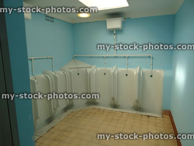 Stock image of gents public toilets, white china urinals for men