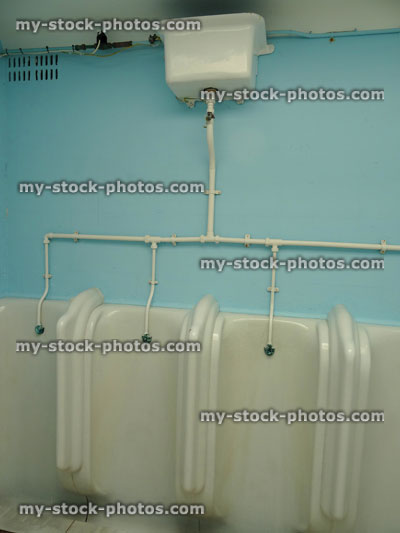 Stock image of white urinals for men in public toilets / gents