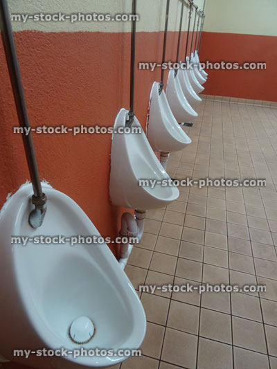 Stock image of row of men's urinals in public toilets / gents