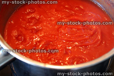 Stock image of homemade tomato sauce for pasta, cooking in saucepan