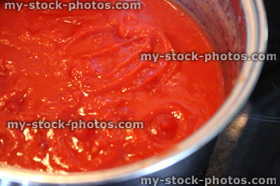 Stock image of homemade tomato sauce for pasta, cooking in saucepan