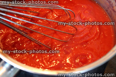 Stock image of homemade tomato sauce for pasta, whisk in saucepan