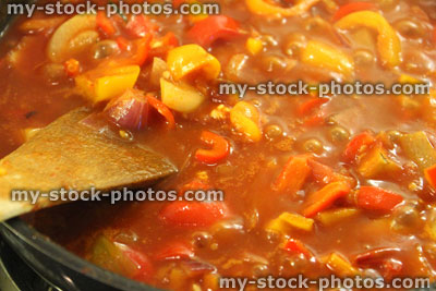 Stock image of tomato ratatouille with onions and red bell peppers, cooking, simmering