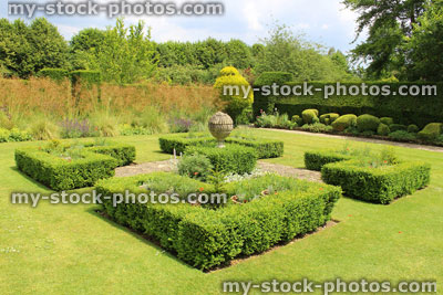 Stock image of landscaped knot garden with geometric clipped buxus hedging