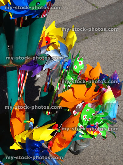 Stock image of rainbow coloured plastic seaside windmills at beach gift shop
