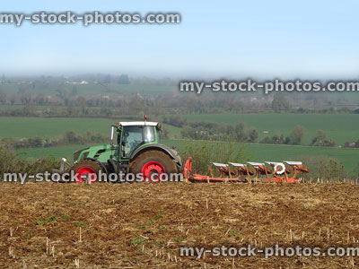 Stock image of farming ploughing farm field in countryside with tractor