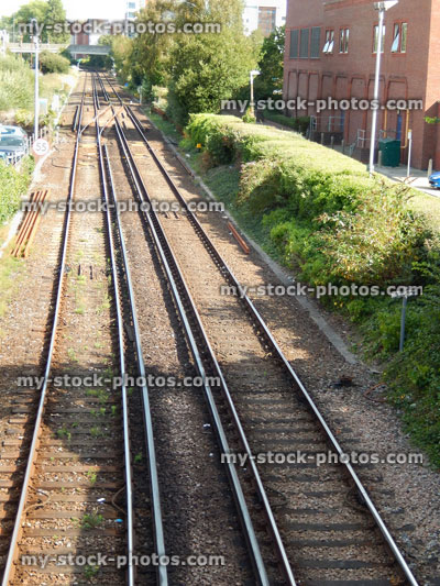 Stock image of railway line / railroad tracks heading through town, passing houses / buildings