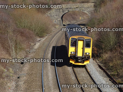 Stock image of diesel train engine, railroad railway line tracks, bridge