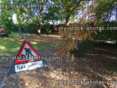 Stock image of triangular, red and white tree cutting sign, warning