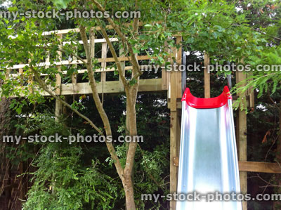 Stock image of homemade treehouse walkway and slide, children's play equipment
