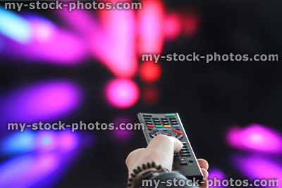 TV remote control / hand, pointing at television screen, changing channels
