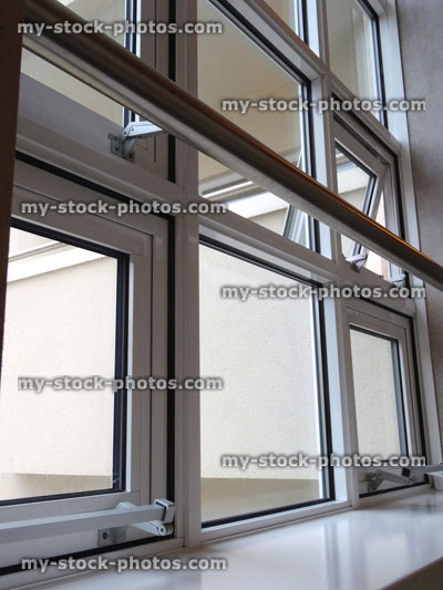 Stock image of white UPVC double glazed window, double glazing, safety bar over windowsill