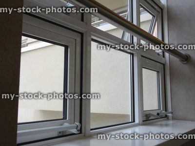 Stock image of white UPVC double glazed window, double glazing, safety bar over windowsill