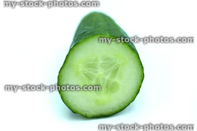 Stock image of fresh organic cucumber, sliced, isolated on white background