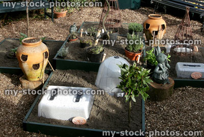 Stock image of raised bed in vegetable garden, terracotta strawberry pots