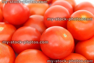 Stock image of fresh, red salad tomatoes in pile, antioxidants, nutrients