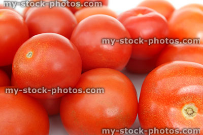 Stock image of fresh, red salad tomatoes in pile, health benefits, antioxidants