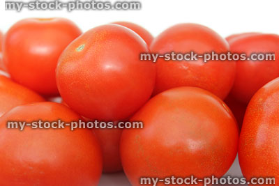 Stock image of fresh, red tomatoes in pile, health benefits, salad vegetable