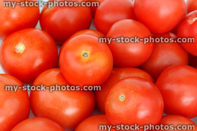 Stock image of fresh, red salad tomatoes in pile, health benefits