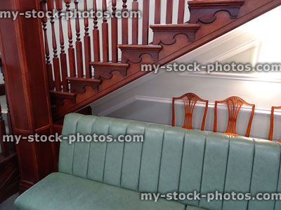 Stock image of wooden staircase spindles, bonket seat / sofa, doctor's waiting room
