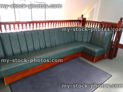 Stock image of private hospital waiting room seating, green leather sofa / bonket seat