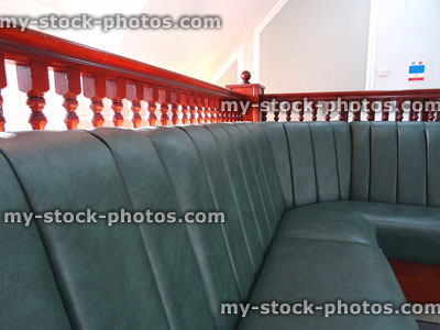 Stock image of private hospital waiting room seats, green leather corner sofa / bonket seating