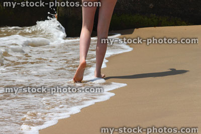 Stock image of girl paddling in sea waves, legs, water, barefoot, seaside beach