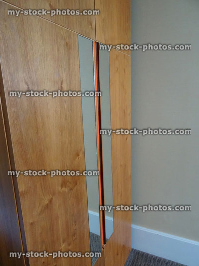 Stock image of beechwood double wardrobe doors in bedroom / full length mirrors