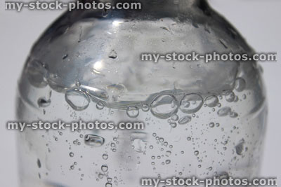 Stock image of bottle of fizzy water, soda water with carbon dioxide bubbles