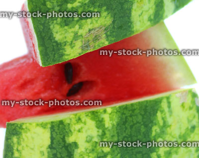 Stock image of watermelon slices, red flesh and green skin / rind