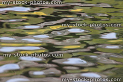 Stock image of dark shadows / reflections on ripples, rippling water surface