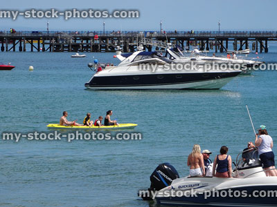 Stock image of families on speed boat and sea kayak / water sports