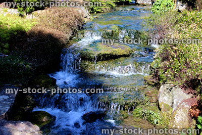 Stock image of cascading waterfall in landscaped garden, running water / stream