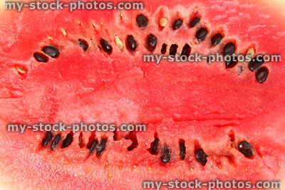 Stock image of red melon / watermelon flesh cut in half with seeds