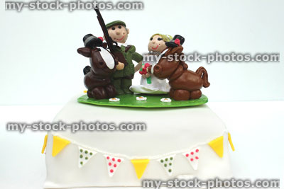 Stock image of homemade wedding cake topper (polymer clay), country bride and groom, horses shotgun