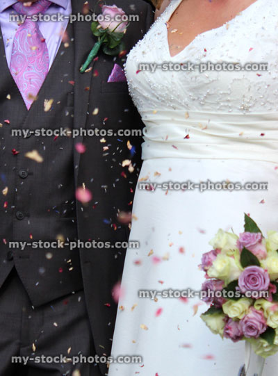 Stock image of newly married couple, bride and groom with confetti