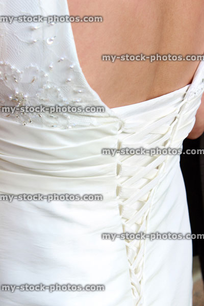 Stock image of white wedding dress back detail, corset bodice with sash ties