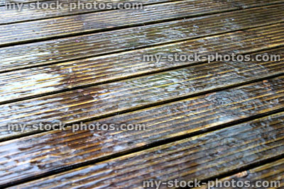 Stock image of rain, rainy weather causing puddle on garden decking