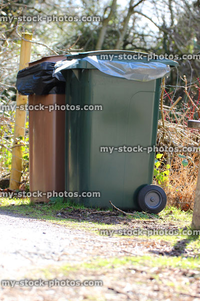 Stock image of brown / green wheelie bins / rubbish dustbins, recycling waste