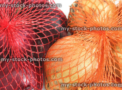 Stock image of red and white onions from supermaket, net bags