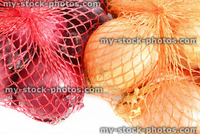 Stock image of red and white onions in string net onion bags
